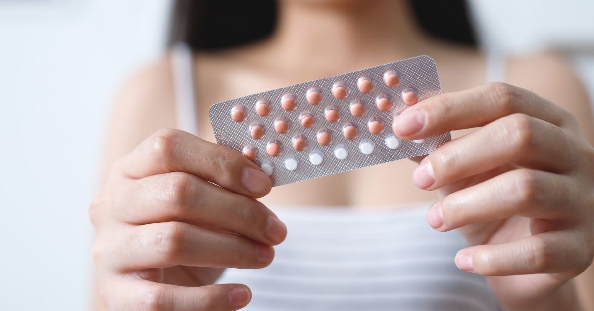 A woman holds birth control pills in this stock image.