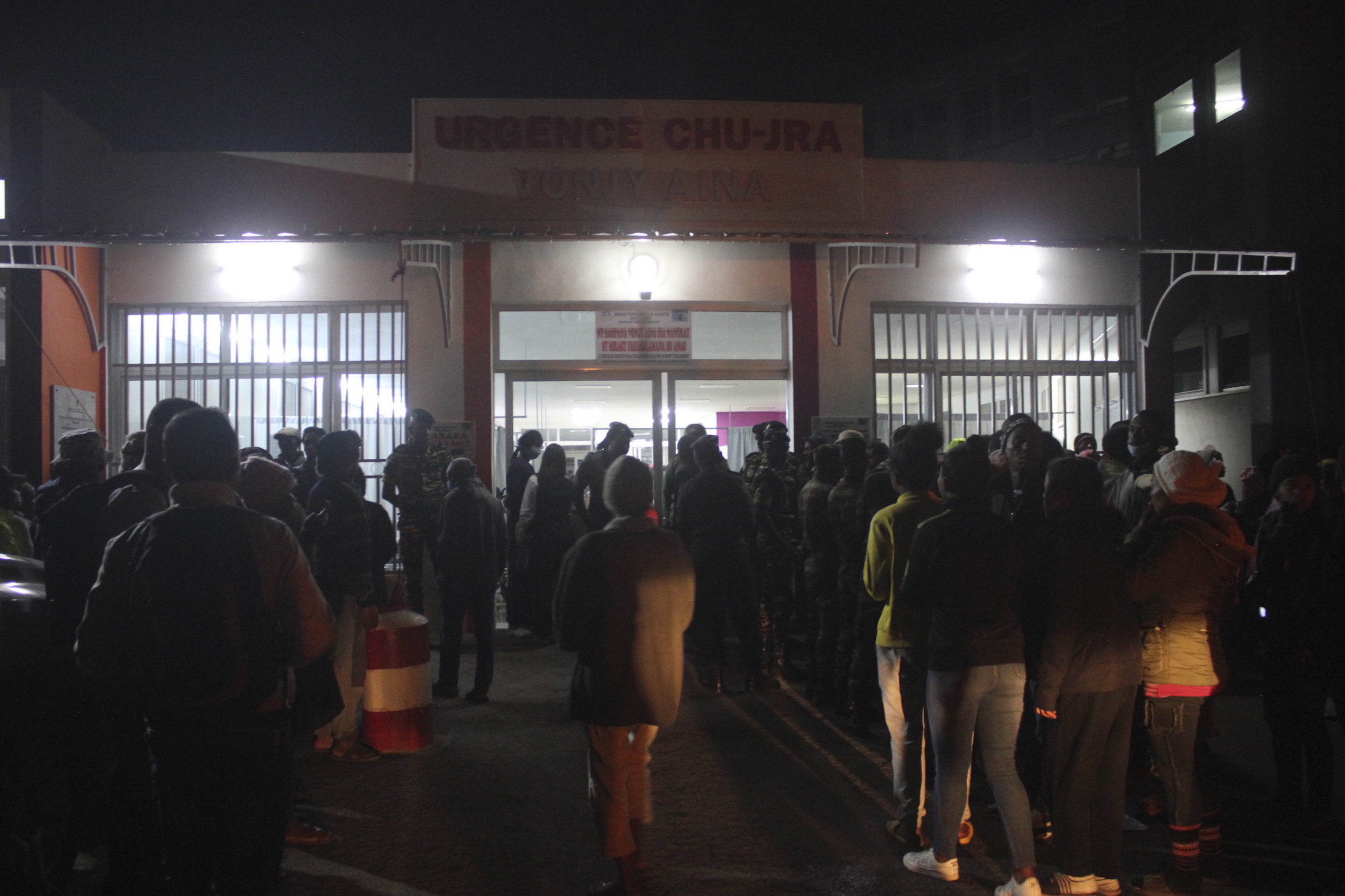 People gather outside a hospital in Antananarivo. Madagascar, on Friday to find out the status of loved ones after a stampede at a local stadium. At least 12 people died in the stampede in the opening ceremony for the Indian Ocean Island Games.