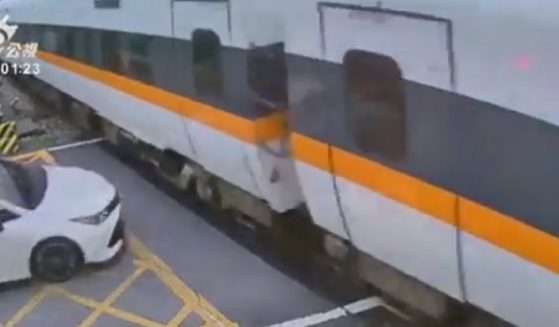 A still captures the moment before a car hit a train at a crossing in Taiwan on Monday.