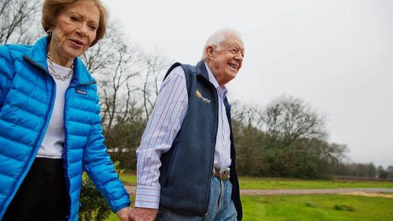 In this Feb. 8, 2017, photo, former President Jimmy Carter, right, and his wife Rosalynn, left, arrive for a ribbon cutting ceremony for a solar panel project on farmland he owns in their hometown of Plains, Georgia. Recently, the former president’s grandson gave a bleak update on his grandfather’s health.