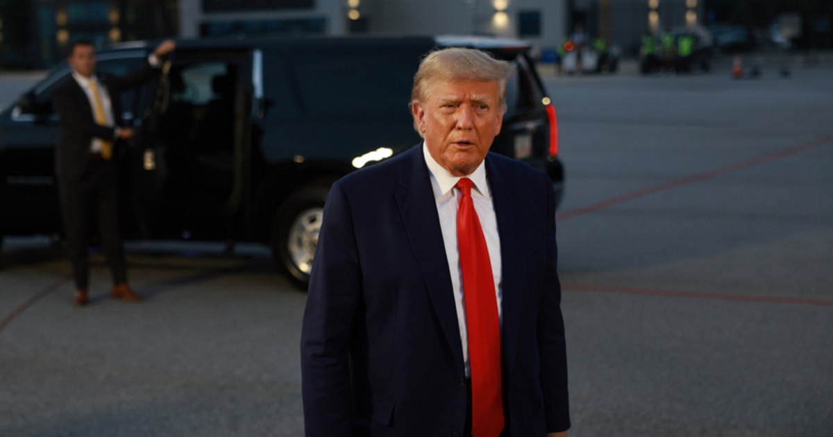 Former President Donald Trump speaks to the media at Atlanta Hartsfield-Jackson International Airport after being booked at the Fulton County jail on Thursday in Atlanta.