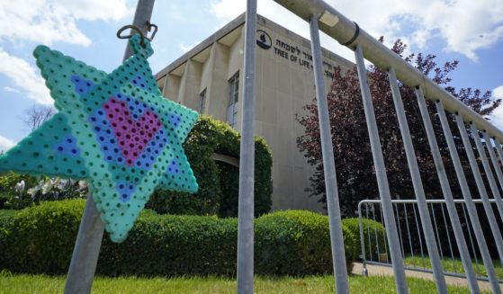 A Star of David hangs from a fence outside the dormant landmark Tree of Life synagogue in Pittsburgh's Squirrel Hill neighborhood on July 13, the day a federal jury announced they had found Robert Bowers, who in 2018 killed 11 people at the synagogue, eligible for the death penalty.