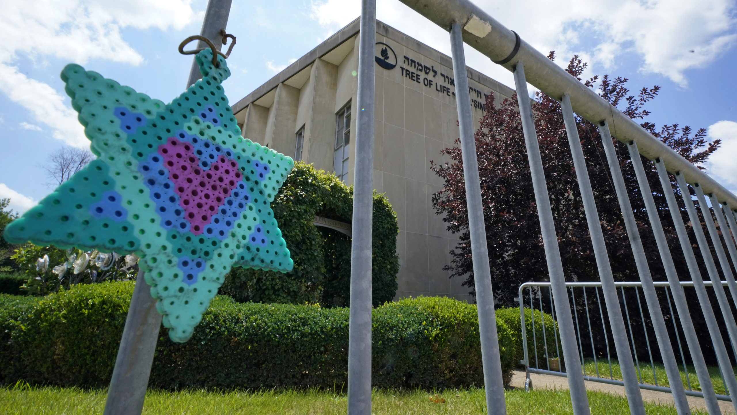 A Star of David hangs from a fence outside the dormant landmark Tree of Life synagogue in Pittsburgh's Squirrel Hill neighborhood on July 13, the day a federal jury announced they had found Robert Bowers, who in 2018 killed 11 people at the synagogue, eligible for the death penalty.