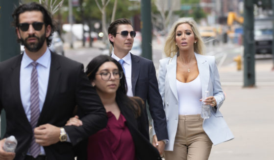 The son, left, and daughter, back right, of Pittsburgh dentist Lawrence “Larry” Rudolph head into federal court for the afternoon session of the trial, July 13, 2022, in Denver.