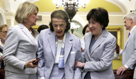 U.S. Sen. Dianne Feinstein (D-CA) (C) is assisted by Sen. Shelley Moore Capito (R-WV) (L), and Sen. Susan Collins (R-ME) (R) after a photo session at the U.S. Capitol on Seersucker Thursday, June 8, 2023 in Washington, DC.