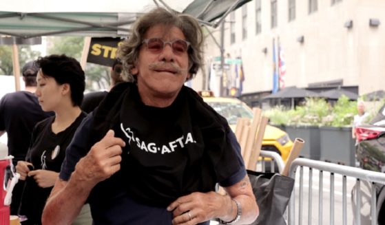 Former Fox News host Geraldo Rivera puts on a T-shirt in July while preparing the join a picket line of striking writers, actors and other media professionals in the SAG and AFTRA unions.