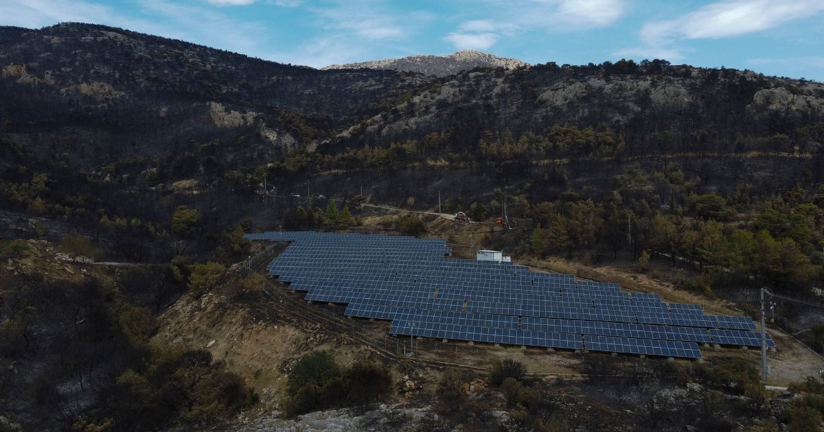 Solar panels are seen near a burned forest in Acharnes suburb, on Mount Parnitha, in northwestern Athens, Greece, on Sunday.