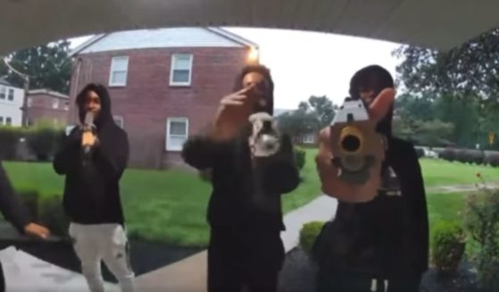 A group of armed youths levels firearms at a doorbell camera in University City, Missouri, on Thursday.