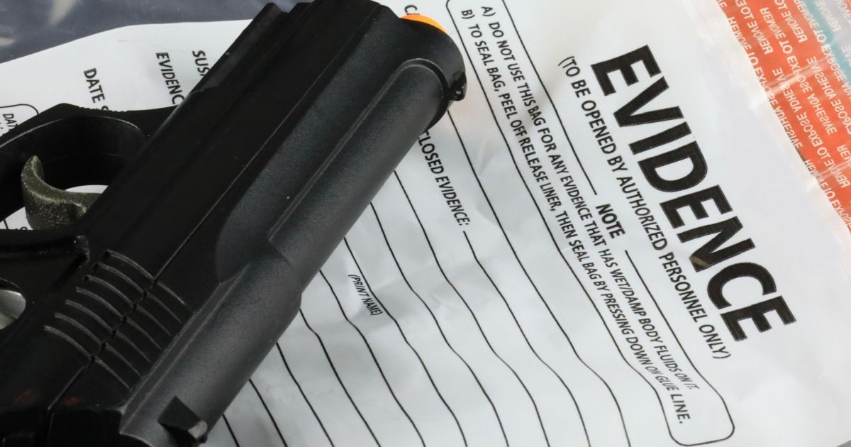 This stock image shows a handgun with an evidence bag.