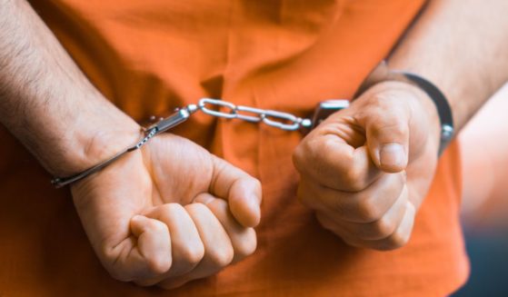 An inmate wears handcuffs in the above stock image.