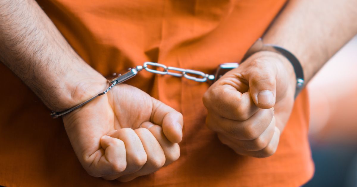 An inmate wears handcuffs in the above stock image.
