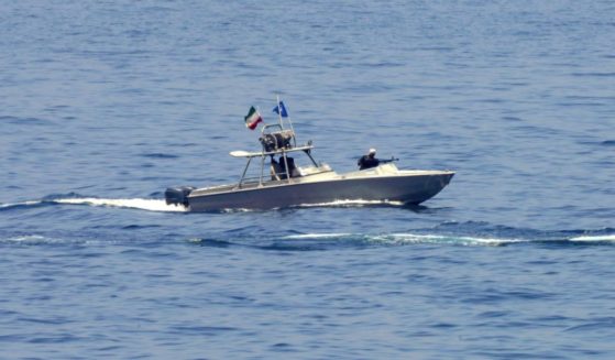 An Iranian Revolutionary Guard vessel watches an American warship in the Strait of Hormuz on May 19.