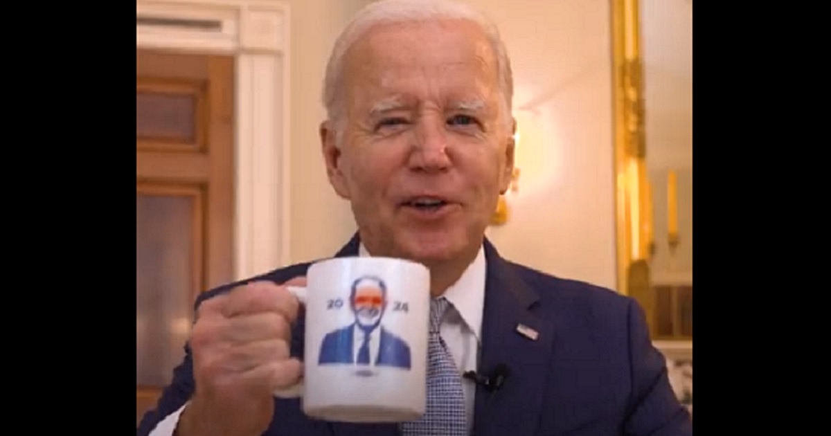 President Joe Biden holds a "Dark Braden" coffee mug in a promo for campaign merchandise.