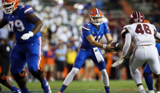 Jalen Kitna of the Florida Gators, center, hands the ball off during the second half of a game against the South Carolina Gamecocks at Ben Hill Griffin Stadium Gainesville, Florida, on Nov. 12.