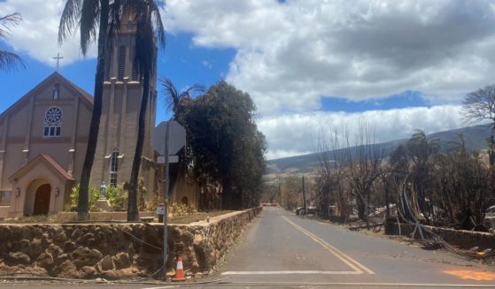 Burned houses are seen adjacent of Maria Lanakila Catholic Church, on Waine street, in the aftermath of a wildfire in Lahaina, western Maui, Hawaii on August 11, 2023.