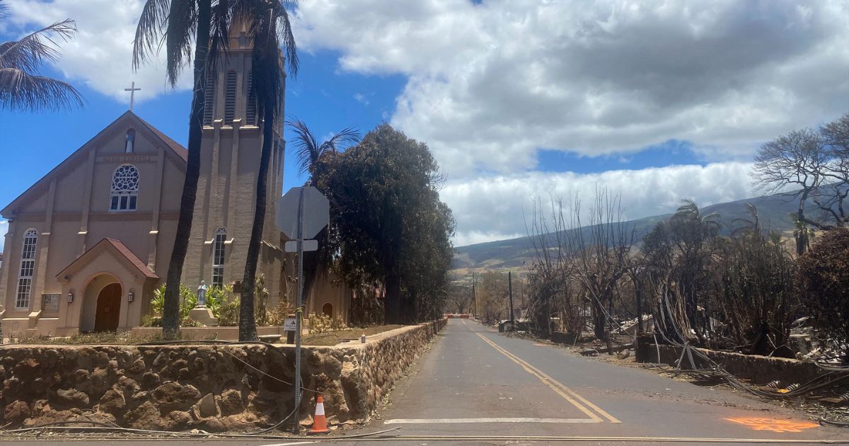Burned houses are seen adjacent of Maria Lanakila Catholic Church, on Waine street, in the aftermath of a wildfire in Lahaina, western Maui, Hawaii on August 11, 2023.