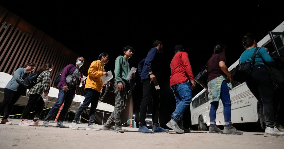 People board a bus after illegally crossing the border from Mexico on July 11 near Yuma, Arizona.