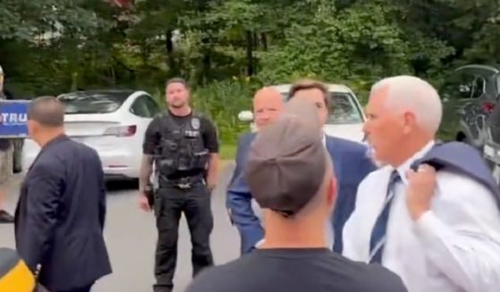 Former Vice President Mike Pence turns to confront a heckler on Friday in Londonderry, New Hampshire.