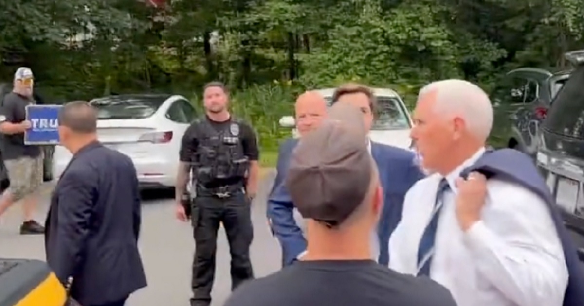 Former Vice President Mike Pence turns to confront a heckler on Friday in Londonderry, New Hampshire.