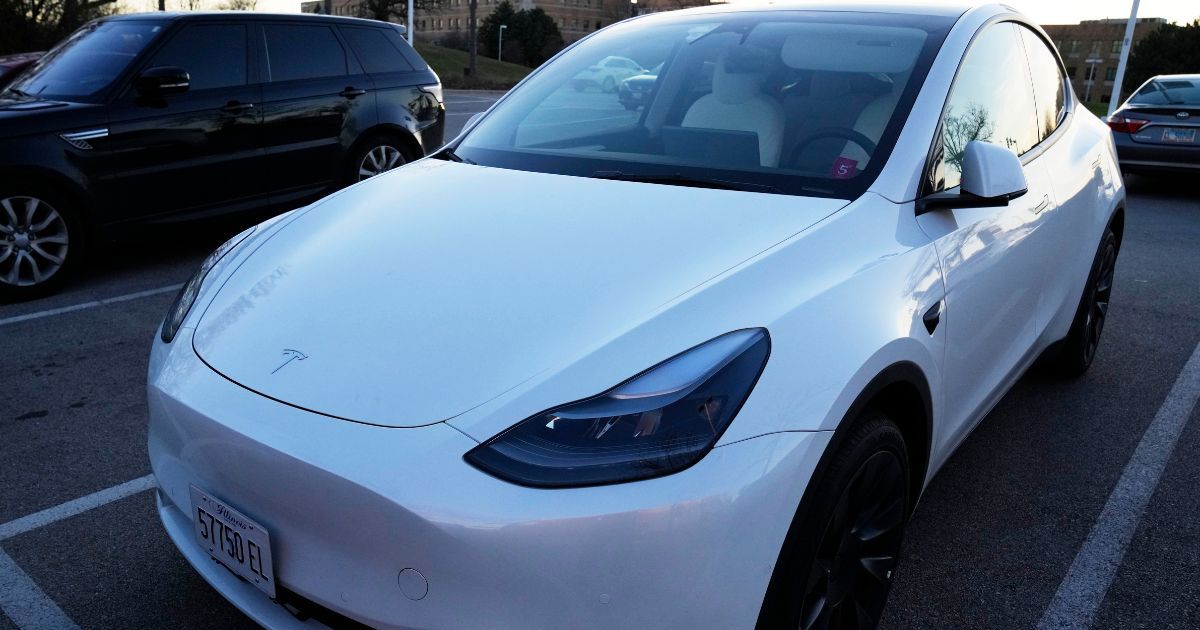 A Tesla Model Y electric vehicle is parked at a shopping plaza in Des Plaines, Illinois, on Dec. 3, 2022.