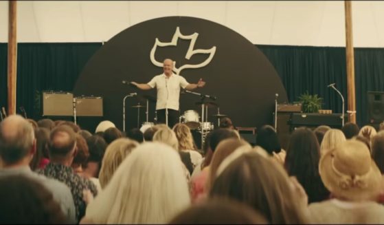 In this frame of "Jesus Revolution," actor Kelsey Grammer, who plays Pastor Chuck Smith, is seen preaching.