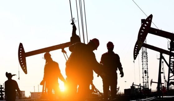 Oil field workers are seen in this stock image.