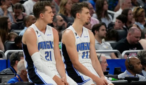 Brothers and Orlando Magic players Moritz Wagner (left) and Franz Wagner (right) wait to check in the during the first half of an NBA basketball game against the Cleveland Cavaliers, on April 4 in Orlando, Florida.