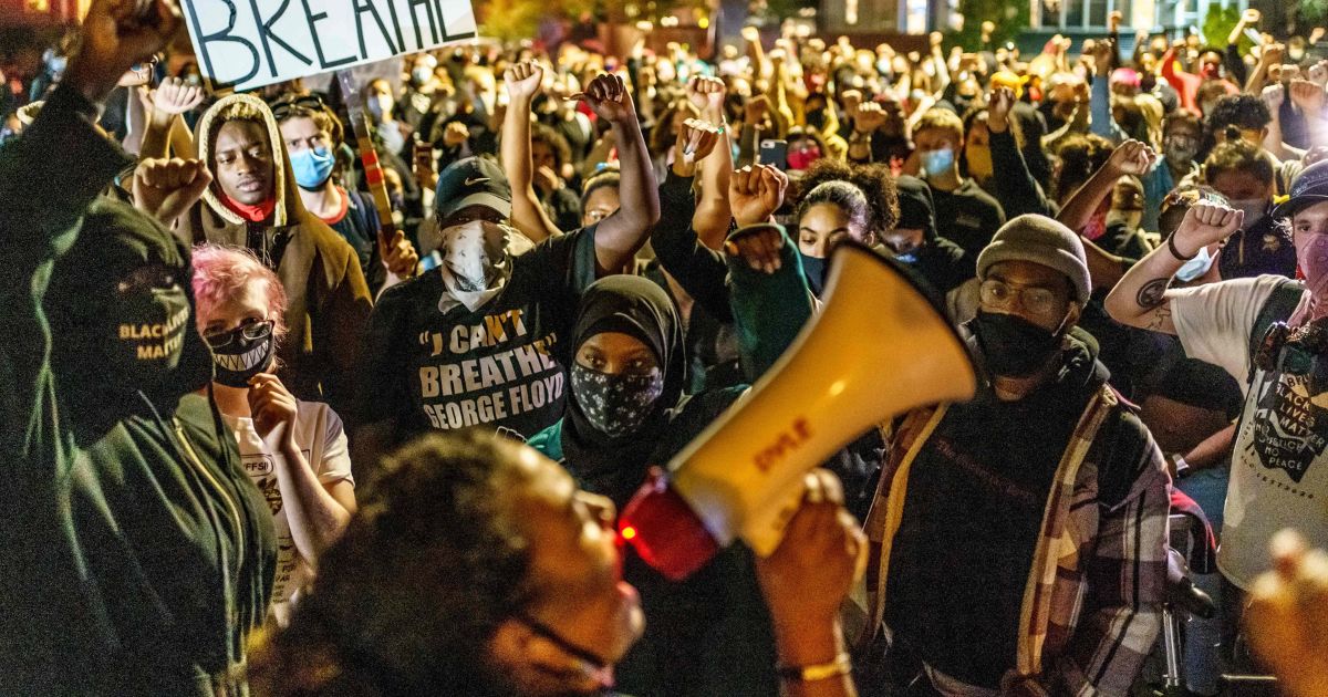Protesters raise their fists during a demonstration after the release on bail of former police officer, Derek Chauvin, in Minneapolis on Oct. 7, 2020.