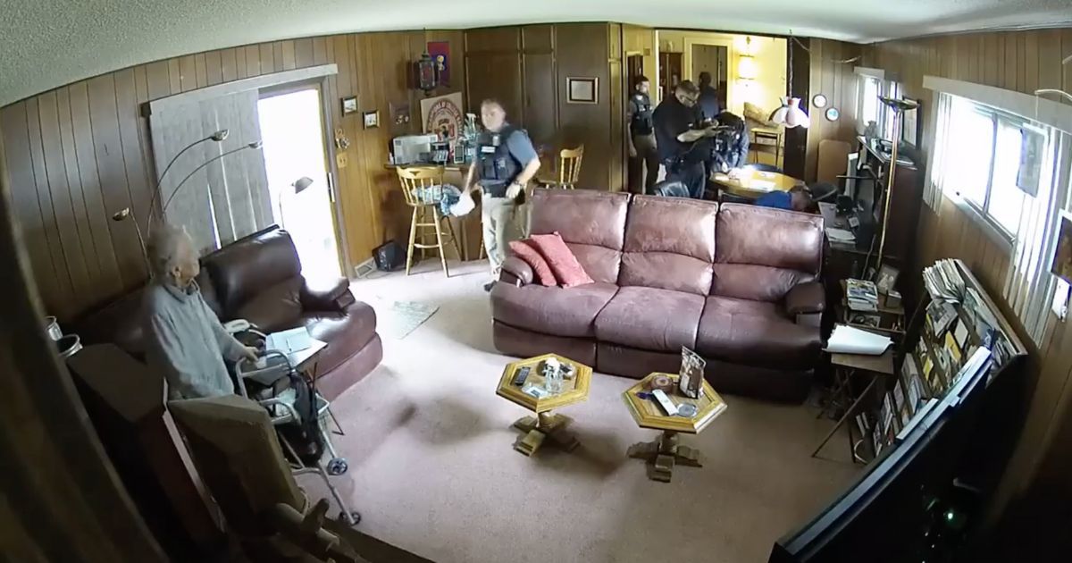 Security camera footage showed a 98-year-old woman who had her house raided by Kansas police officers.