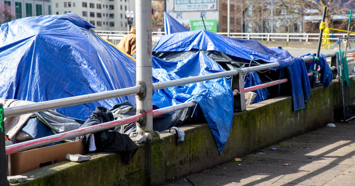 A homeless encampment is seen in the above stock image.
