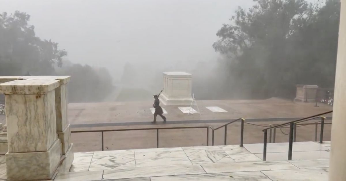 In a post from Sunday, a soldier watches over the Tomb of the Unknown Soldier, despite 60-85 mph wind and rain. (@pneaville / Twitter screen shot)