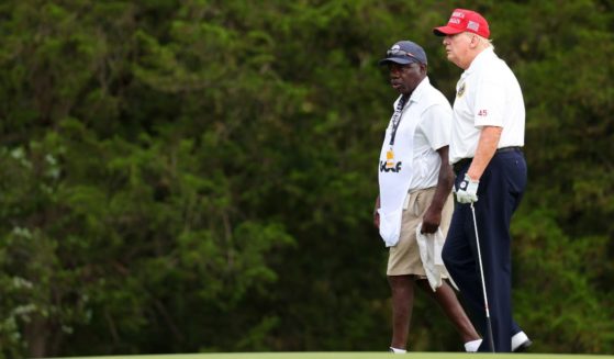 Former President Donald Trump talks with his caddie during the pro-am prior to the LIV Golf Invitational - Bedminster at Trump National Golf Club on Aug. 10 in Bedminster, New Jersey.