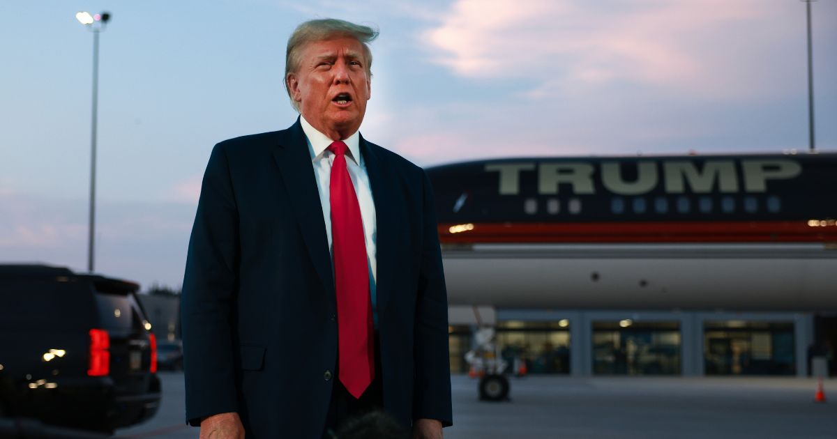 Former President Donald Trump speaks to the media at Atlanta Hartsfield-Jackson International Airport after surrendering at the Fulton County jail on Thursday in Atlanta.