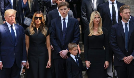 Former President Donald Trump and his wife Melania Trump, both left, along with their son Barron Trump, center, and Ivanka Trump, Eric Trump and Donald Trump Jr., all on the right, watch as the casket of Ivana Trump is put in a hearse outside of St. Vincent Ferrer Roman Catholic Church during her funeral on July 20, 2022, in New York City.