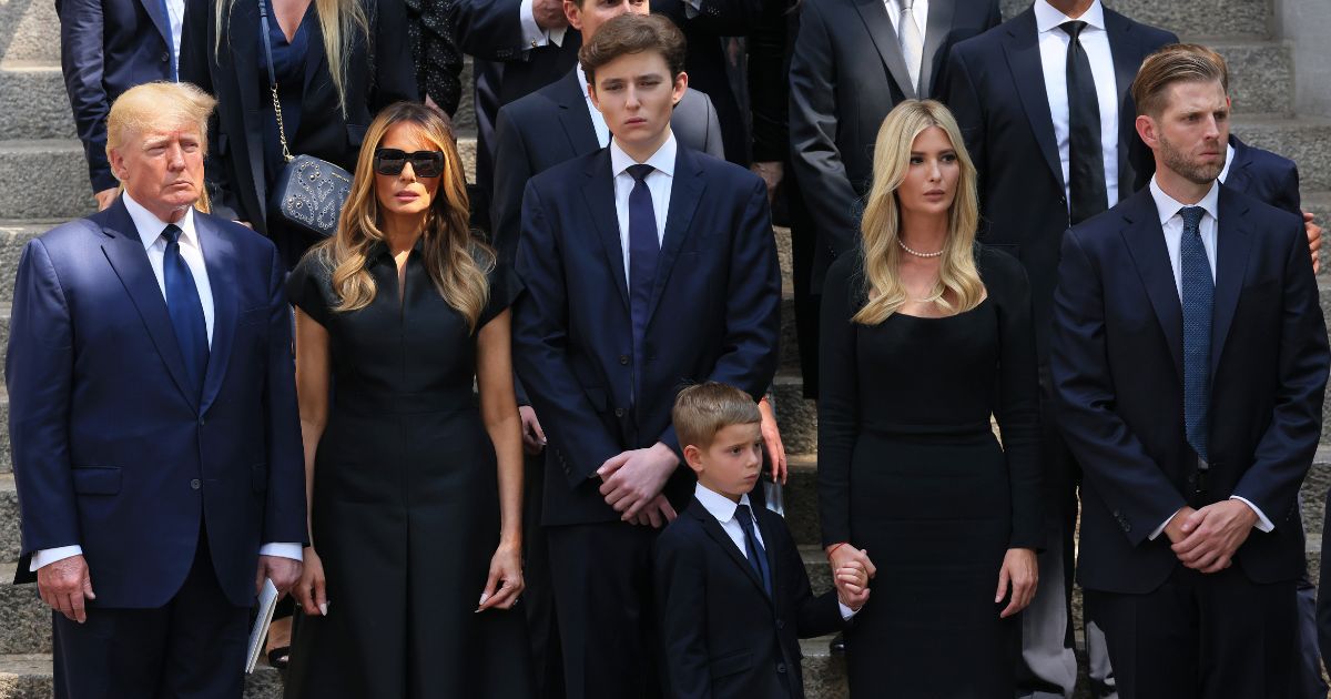 Former President Donald Trump and his wife Melania Trump, both left, along with their son Barron Trump, center, and Ivanka Trump, Eric Trump and Donald Trump Jr., all on the right, watch as the casket of Ivana Trump is put in a hearse outside of St. Vincent Ferrer Roman Catholic Church during her funeral on July 20, 2022, in New York City.