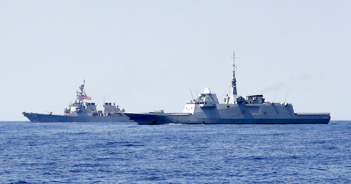 A photo taken on August 7, 2019, shows the US Navy USS Donald Cook class guided missile destroyer (L) and the French anti-submarine frigate FREMM Auvergne (R) during an exercise in the Mediterranean sea.