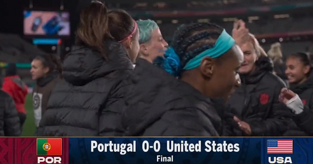 Controversial soccer player Megan Rapinoe (blue hair) dances with fellow members of the U.S. Women's National Team after a tie game in New Zealand in the Women's World Cup.