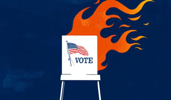 This illustration photo shows a voting booth in flames.