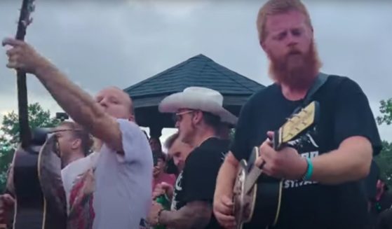 Oliver Anthony, right, joined Shinedown and Papa Roach for an impromptu acoustic concert after a Virginia music festival was cancelled due to severe weather.