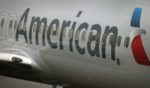 A new American Airlines 737-800 aircraft featuring a new paint job with the company’s new logo sits at a gate at O'Hare Airport in Chicago, Illinois, on Jan. 19, 2013.