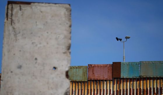 Pictured is the wall that separates the United States from Mexico, near a slab of the Berlin Wall, in Tijuana, Mexico, on Aug. 25.