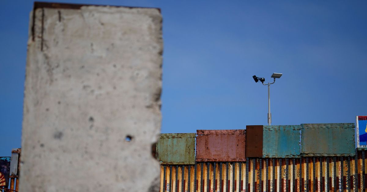 Pictured is the wall that separates the United States from Mexico, near a slab of the Berlin Wall, in Tijuana, Mexico, on Aug. 25.