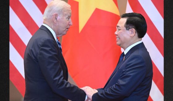 President Joe Biden, left, shakes hands with Vuong Dinh Hue, right, Chairman of Vietnam's National Assembly, during a meeting in Hanoi Monday.