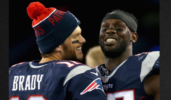 Chandler Jones #95, right, is seen with Tom Brady #12 during the fourth quarter against the Miami Dolphins at Gillette Stadium on Oct. 29, 2015, in Foxboro, Massachusetts.