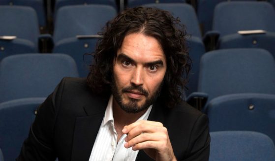 Actor and comedian Russell Brand poses for photographs at the Institute of Education in London on Nov. 25, 2014.