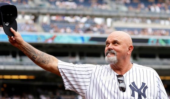 Former New York Yankees pitcher David Wells gestures to the crowd during the Old Timers' Day ceremony before the Yankees' baseball game against the Milwaukee Brewers on Saturday.