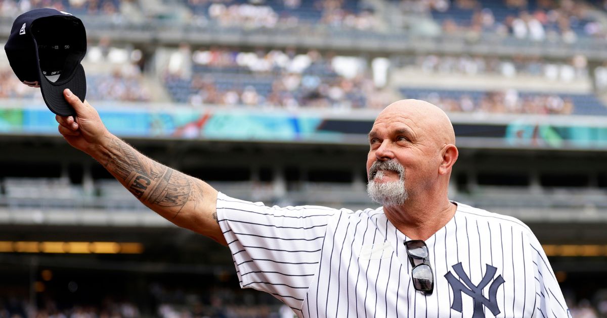 Former New York Yankees pitcher David Wells gestures to the crowd during the Old Timers' Day ceremony before the Yankees' baseball game against the Milwaukee Brewers on Saturday.
