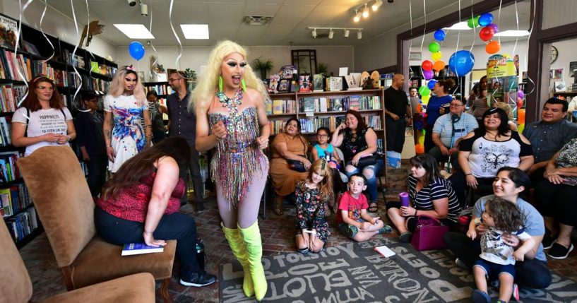 Drag queen Athene Kills, center, arrives to awaiting adults and children for Drag Queen Story Hour at Cellar Door Books in Riverside, California, on June 22, 2019. Drag queen story hours have become a controversial topic in recent years, with many actively opposing the practice and public funding of such a practice.