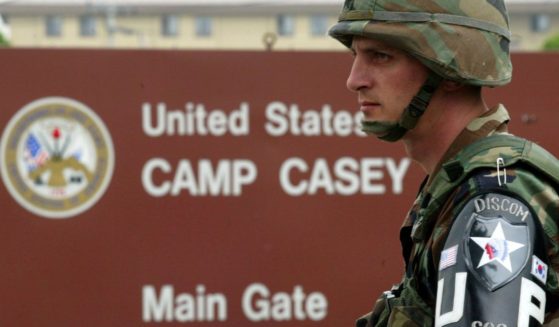 A U.S. soldier from the 2nd Infantry Division stands guard at the main gate of 2nd U.S. Infantry Division headquarters in Dongducheon, South Korea, on June 8, 2004.