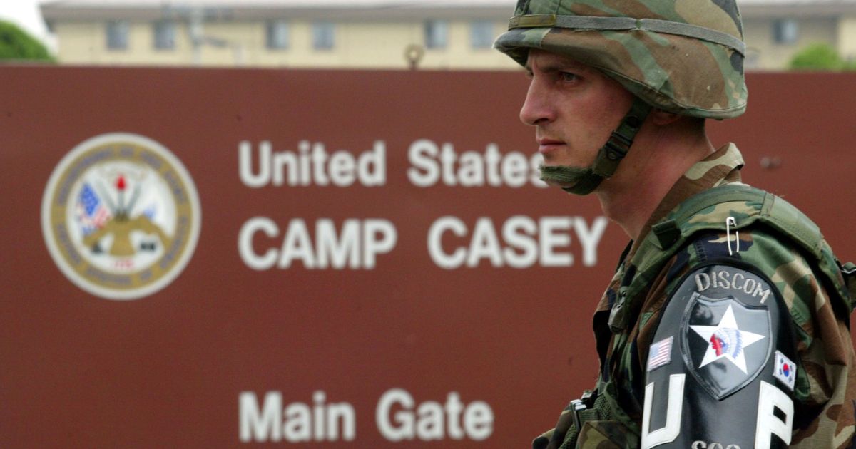 A U.S. soldier from the 2nd Infantry Division stands guard at the main gate of 2nd U.S. Infantry Division headquarters in Dongducheon, South Korea, on June 8, 2004.